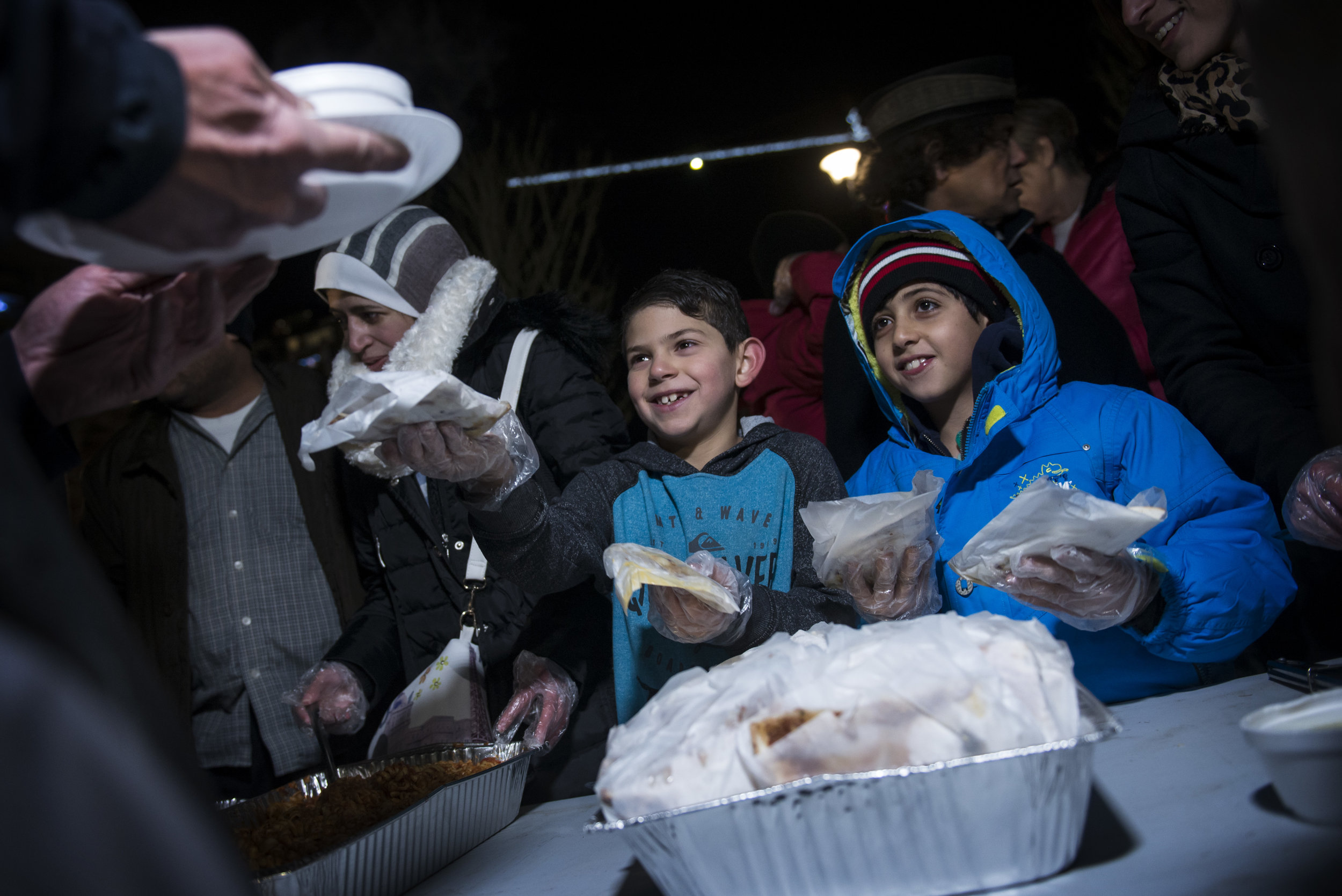Syrian refugees in Calgary hosted a potluck dinner with YYC Helping Homeless on December 22, 2016. Rayan Sanaoubar, 8, and Ahmad Sawaiah, 9, handed out meals of pasta, soup and a traditional Syrian rice dish to people experiencing homelessness in East Village that evening.