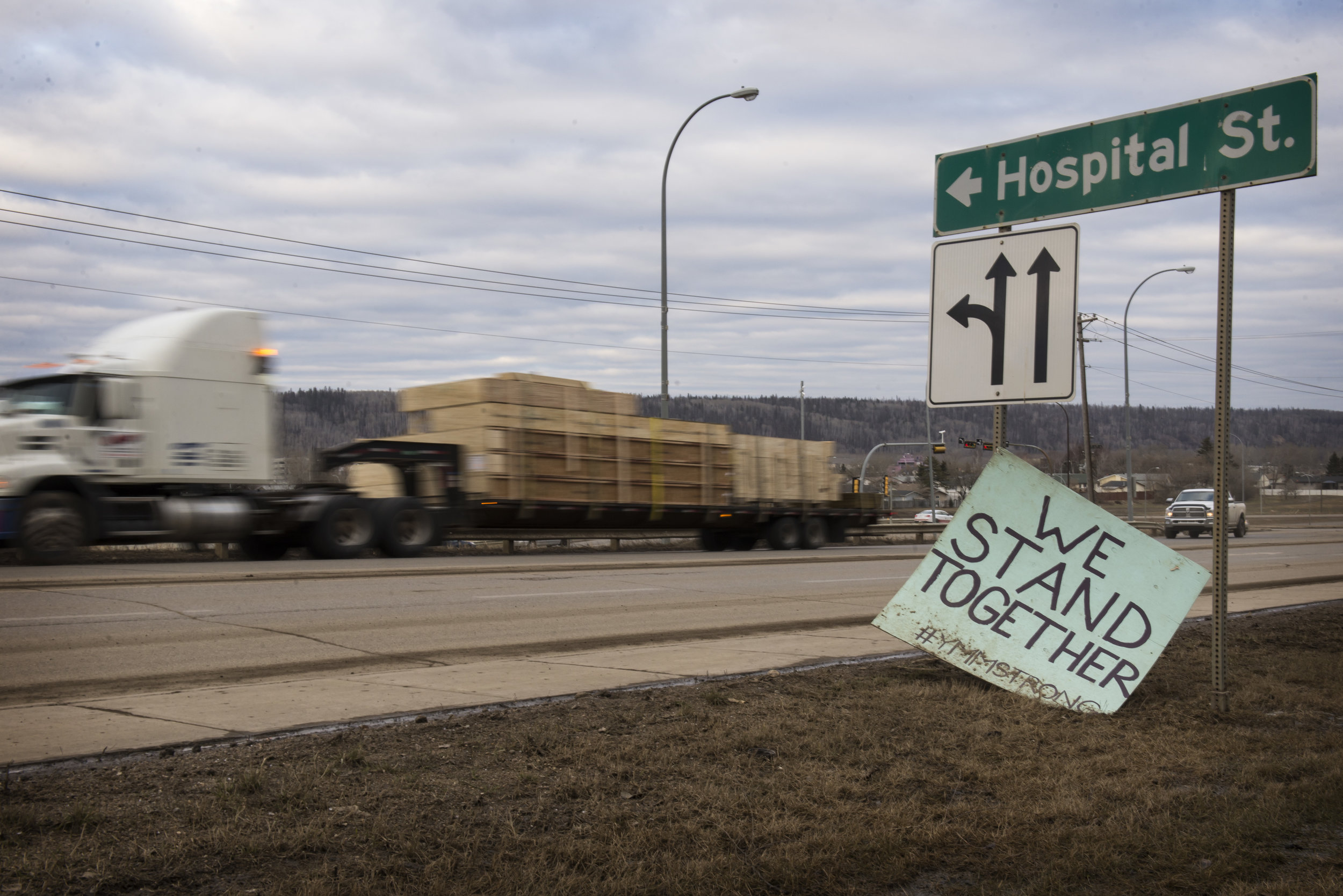 Relics of the community’s motto, “we stand together,” stand in Fort McMurray as trucks carry supplies to the communities and homes that are still being rebuilt.