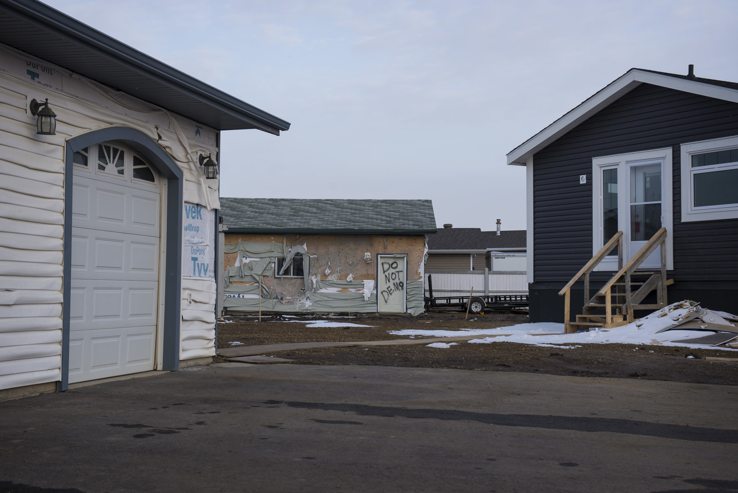 Despite not being engulfed in flames, some homes were so close to the heat that the siding melted off the buildings. 