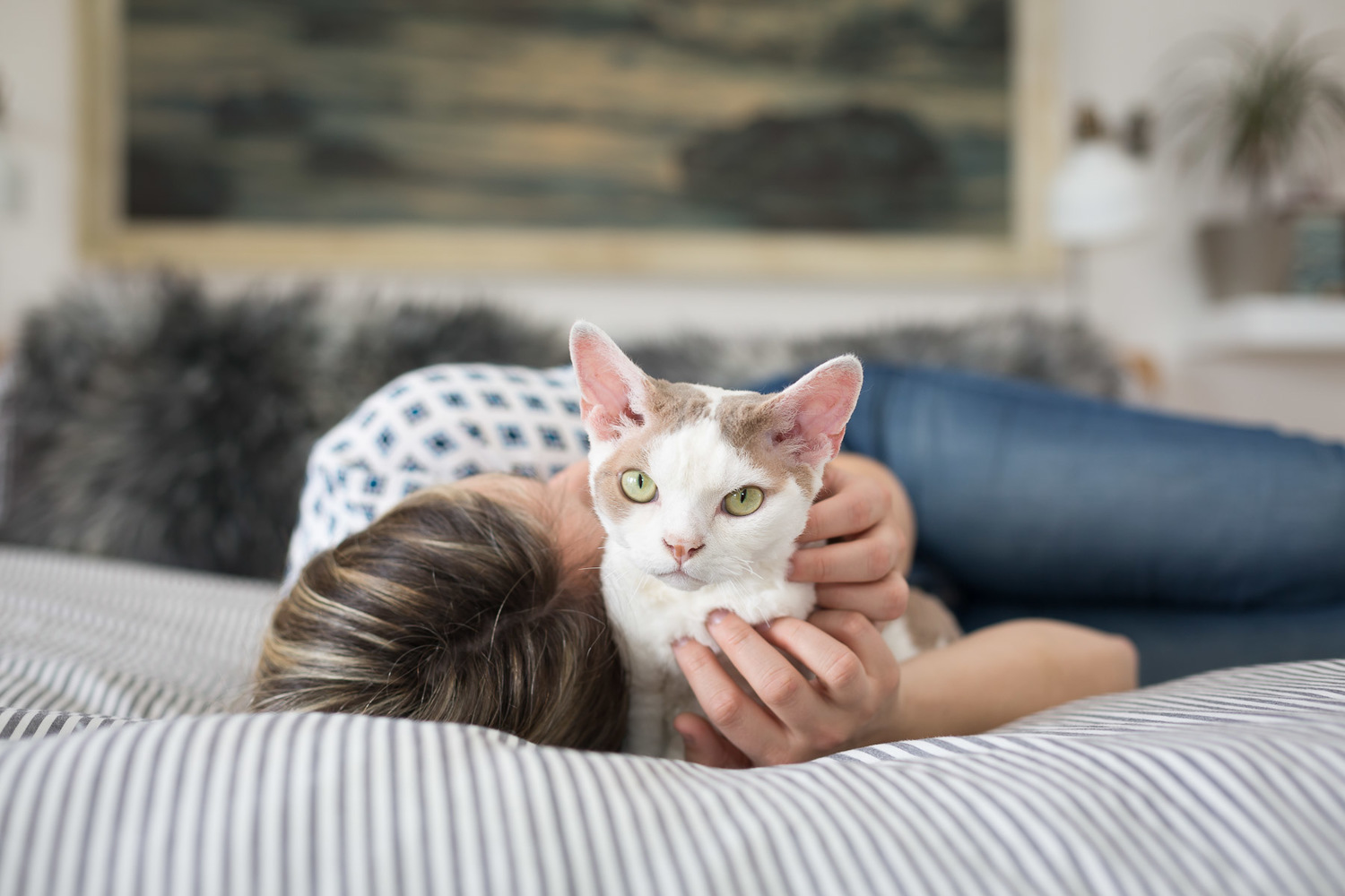 Girl chilling on her bed with her beautiful Devon Rex Cat Moose.