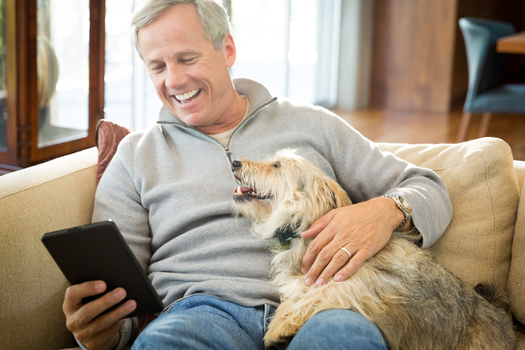 attractive-man-with-dog-reading-couch.jpg