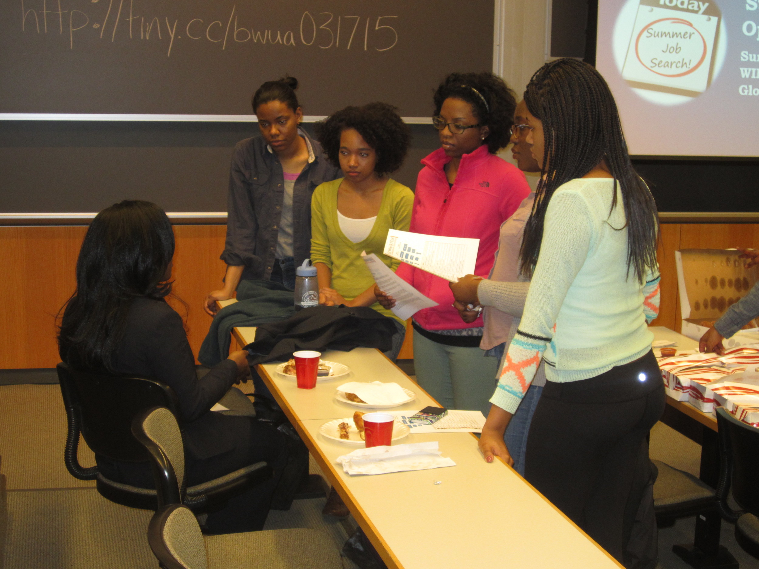 Director of Alumni Relations, Fola Onifade, talking to a few underclassmen about her experience studying abroad in France during Penn's Summer in Tours study abroad program.