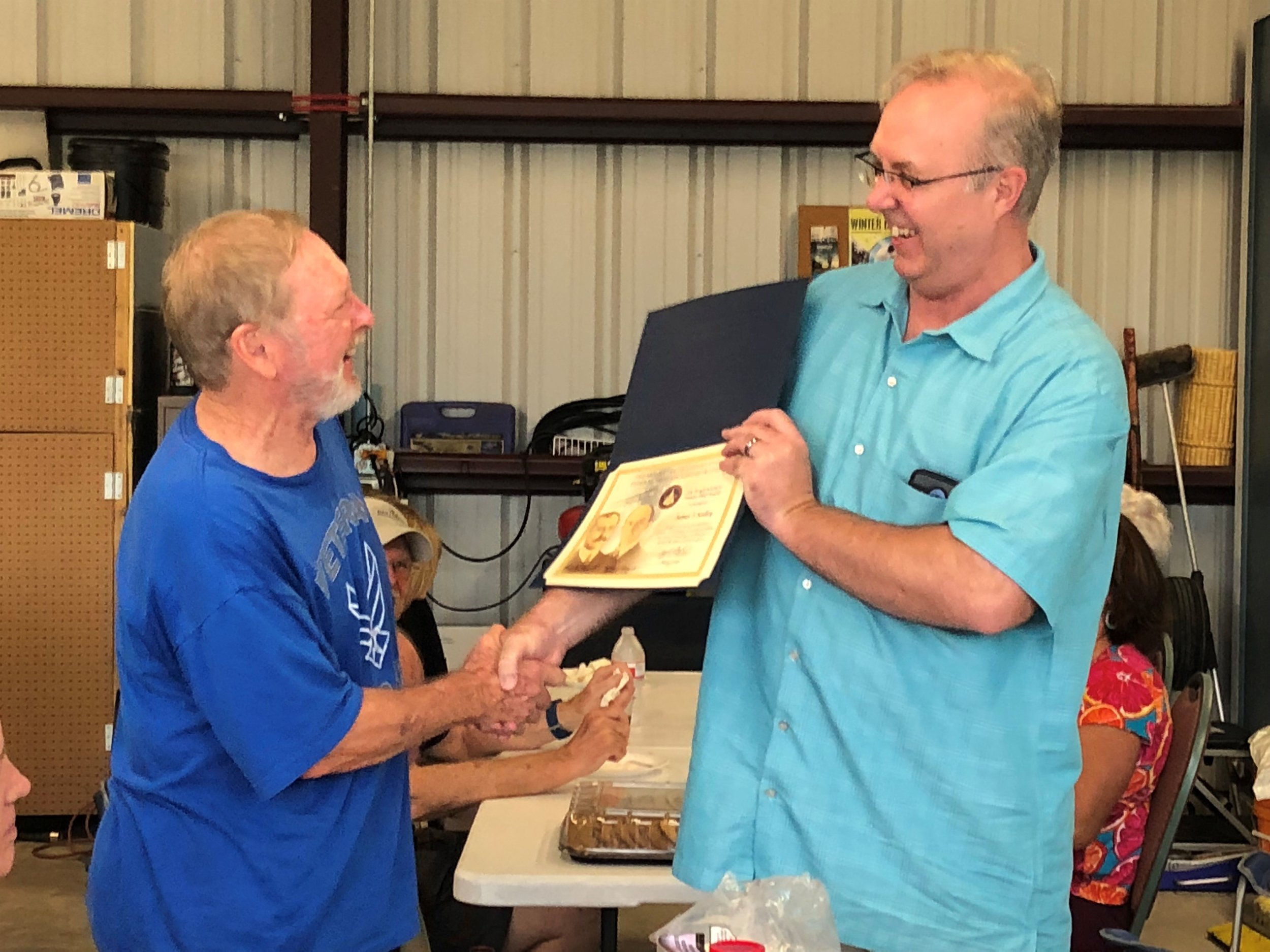Jim Kelley (left) receiving the FAA Master Pilot award from Lance Little.