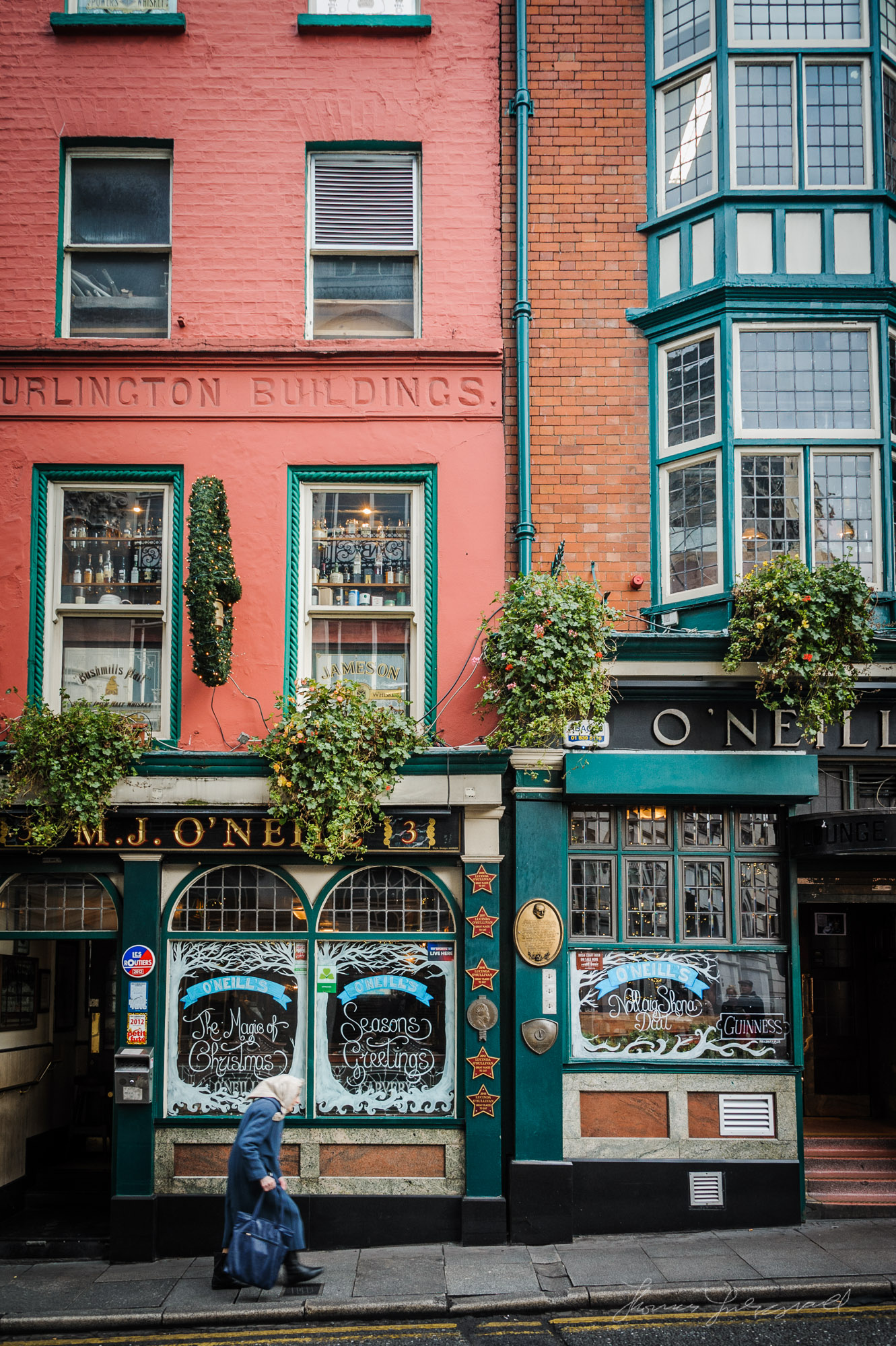 Old Lady walking by O'Neill's Pub in Dublin