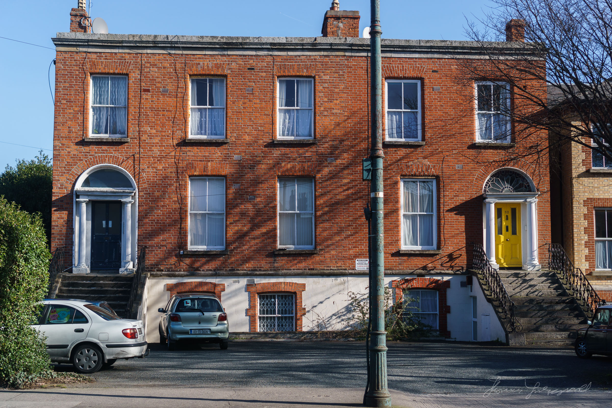 Not a great subject, or photo, but I love the colours and the way the light interacts with the building, from the shadows to the way the sun is falling on the white painted areas around the doors.