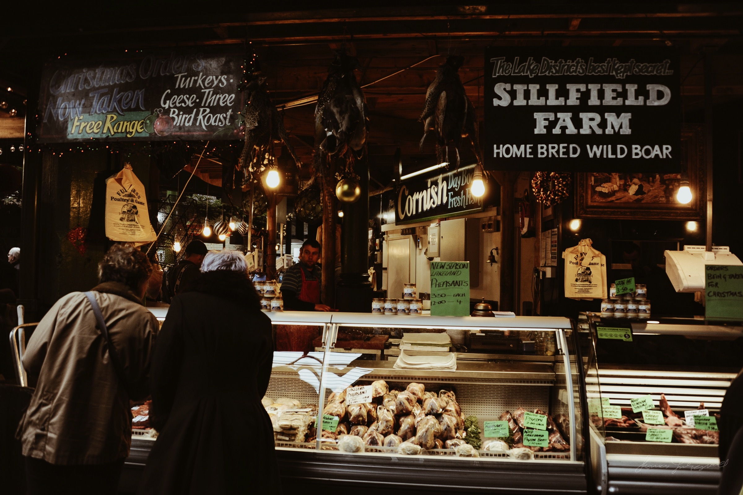 People at a butchers in the Borough market in London