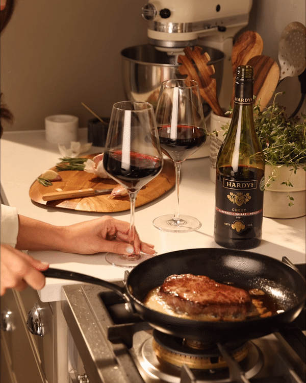 Wine is being swirled while a steak is cooking in the foreground. As part of a Hardys social media campaign.
