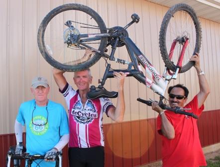 Mayor Pro Tem Randy Bland, deCycles Director Dr. Norm Houze, and Rev. Jack Daniel (Holding up the pastor’s bike that isn’t proper for cross country riding…but made it through town.)