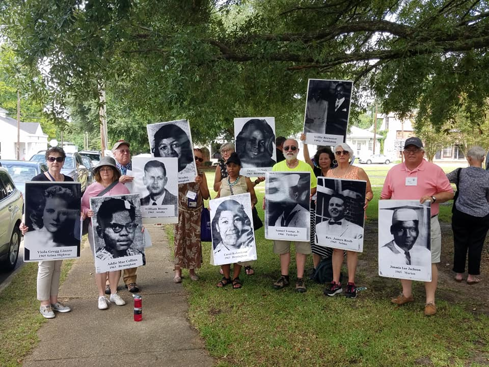 group with signs on lawn.png