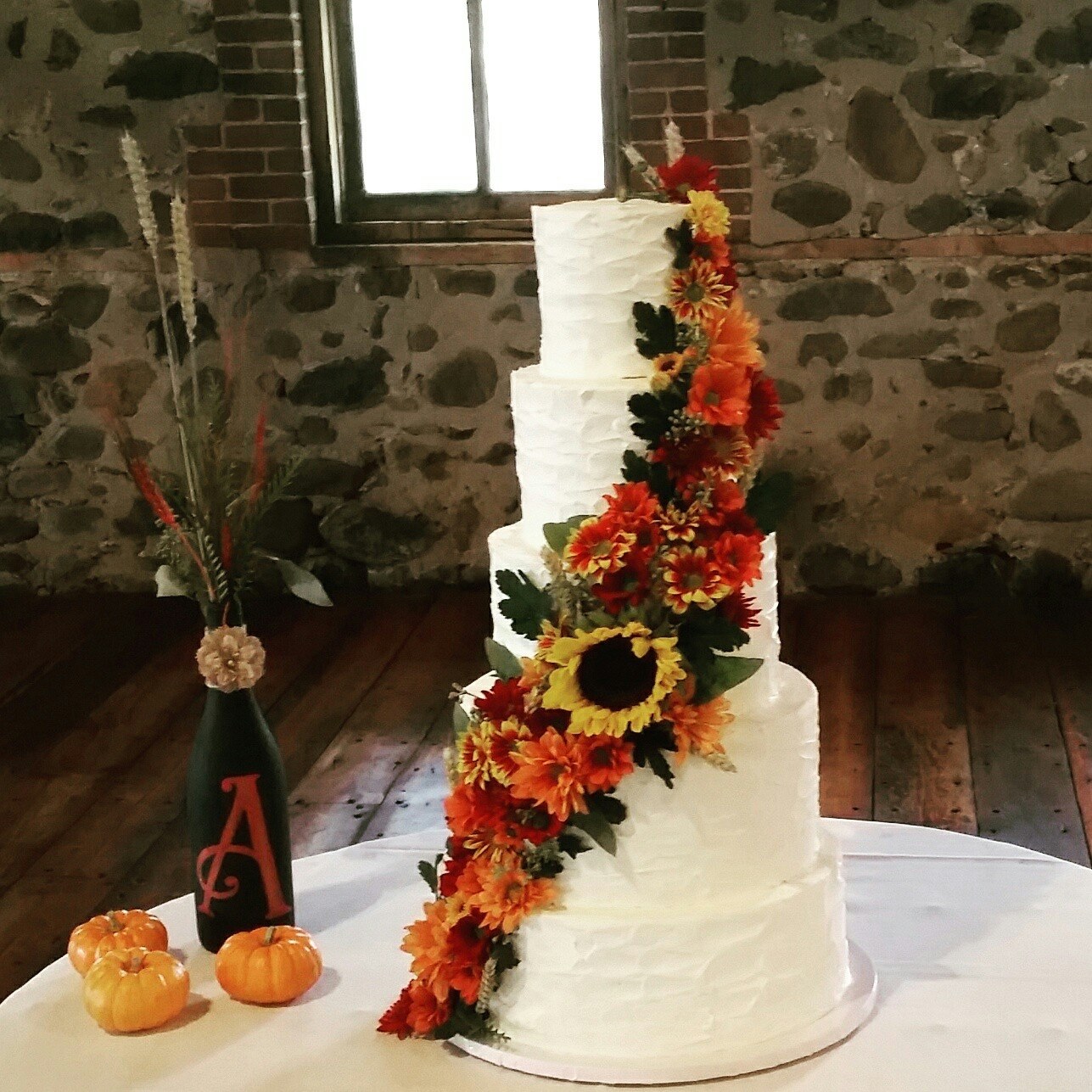 Fall wedding cake with cascading fresh flowers