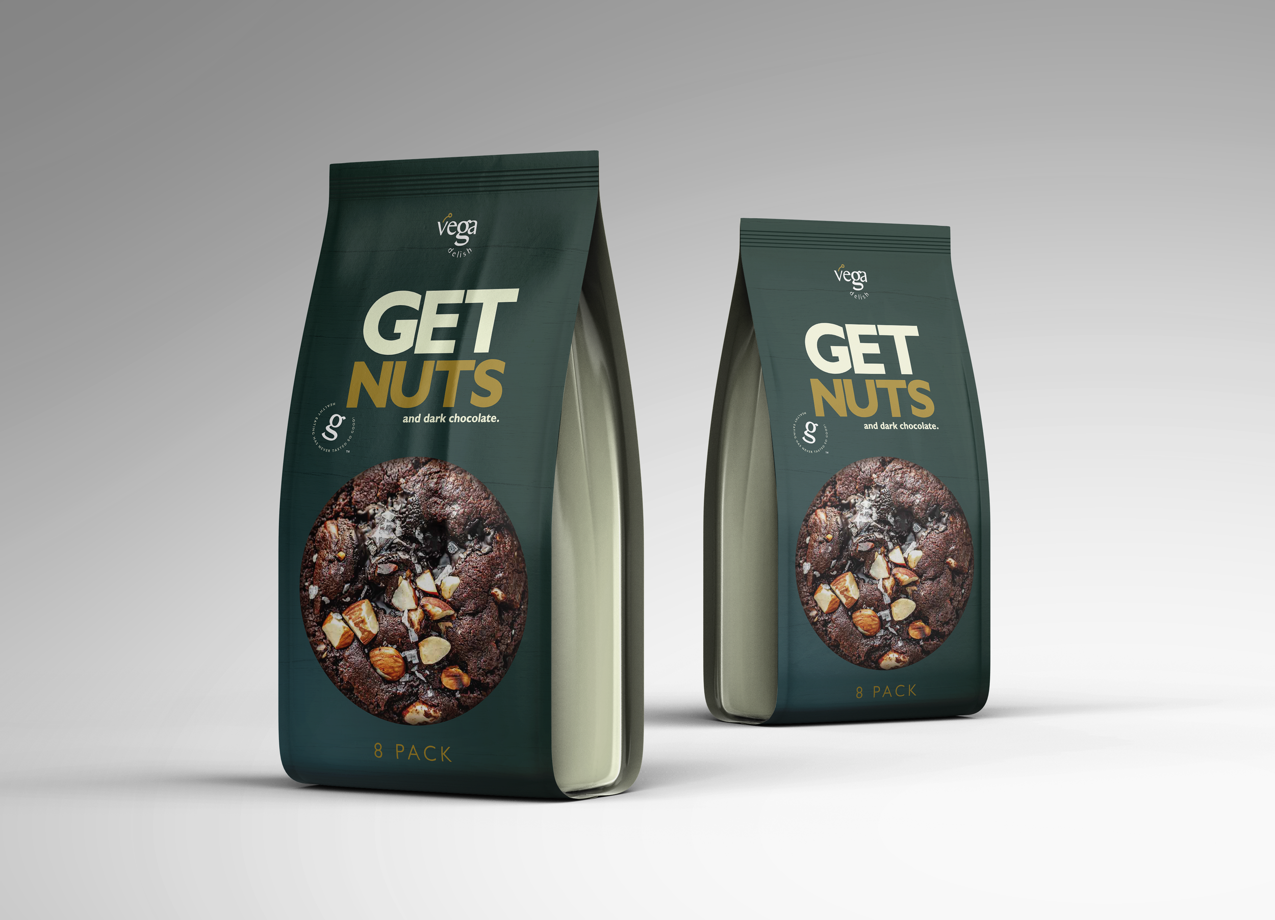 Two dark green stand-up pouches of Vega Get Nuts dark chocolate snack packaging. Each bag features bold 'GET NUTS' text, a large image of a chocolate cookie topped with nuts and sea salt, the Vega logo, and '8 PACK' at the bottom.
