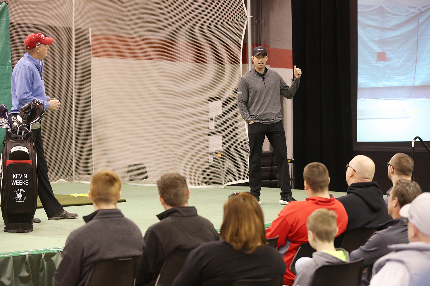 Former Chicago Bears placekicker Robbie Gould took the stage to talk his love of golf and get some tips from IPGA pro Kevin Weeks (left)