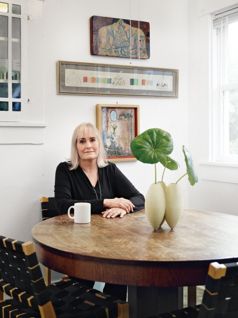 Judy Russell relaxes in their breakfast room at a sturdy antique oak pedestal table, from her family's home in Bellaire.