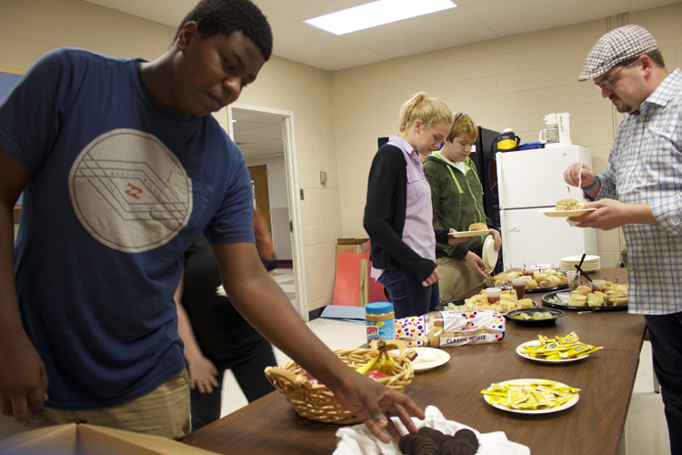  Lighting director Myles Roddy (foreground) and some of the other crew members enjoy dinner provided by the Poplar Pike Arts Guild.&nbsp; 