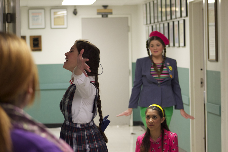 Hayley Bardos, who plays Marcy Park, practices outside of the make-up room before actors are called onstage. 