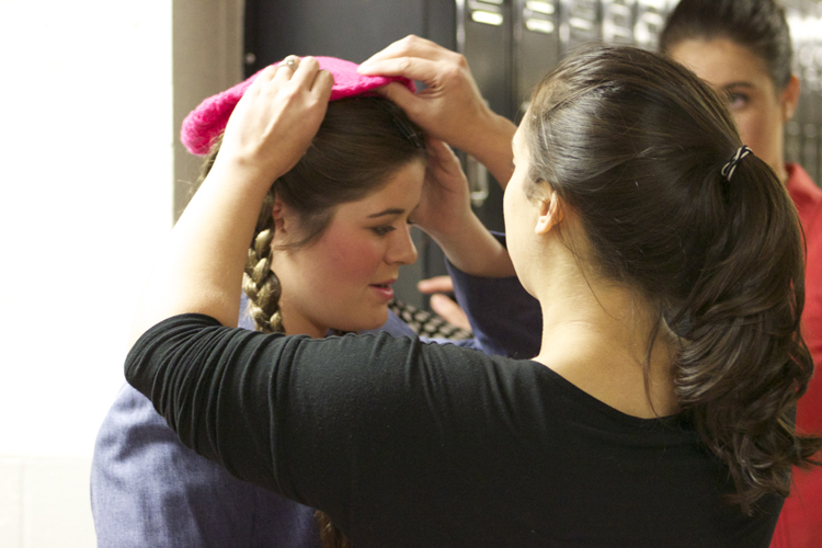  Director Kirie Walz makes sure everything is just right on Kaylynn Coulter's costume before the dress rehearsal begins. 
