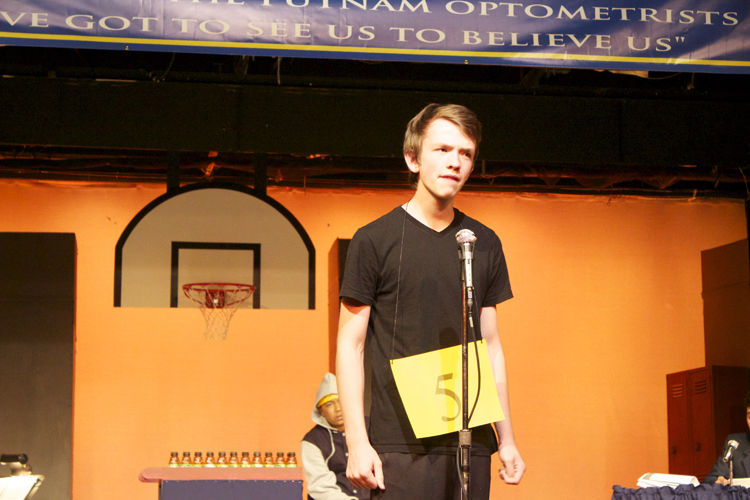 Audience volunteer Elijah Bienz faces his first word of the competition.