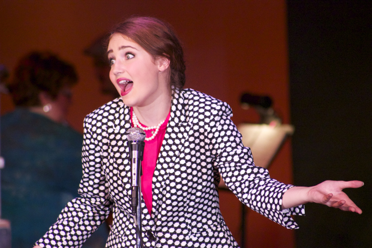 Perretti keeps the Bee running smoothly, and even entertains the crowd with her choice information on the competitors. 