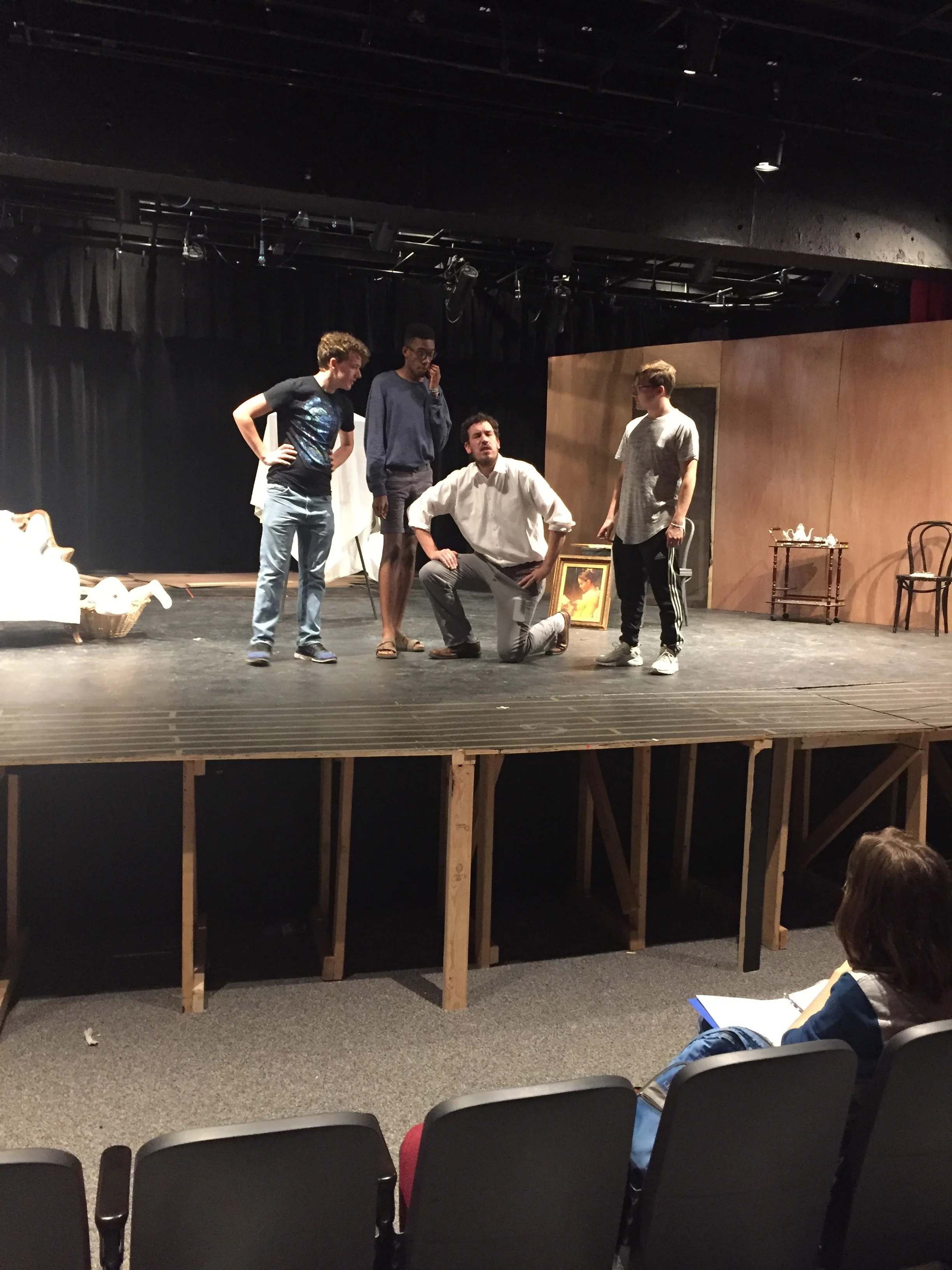 Director Jeff White works with 3 actors onstage.