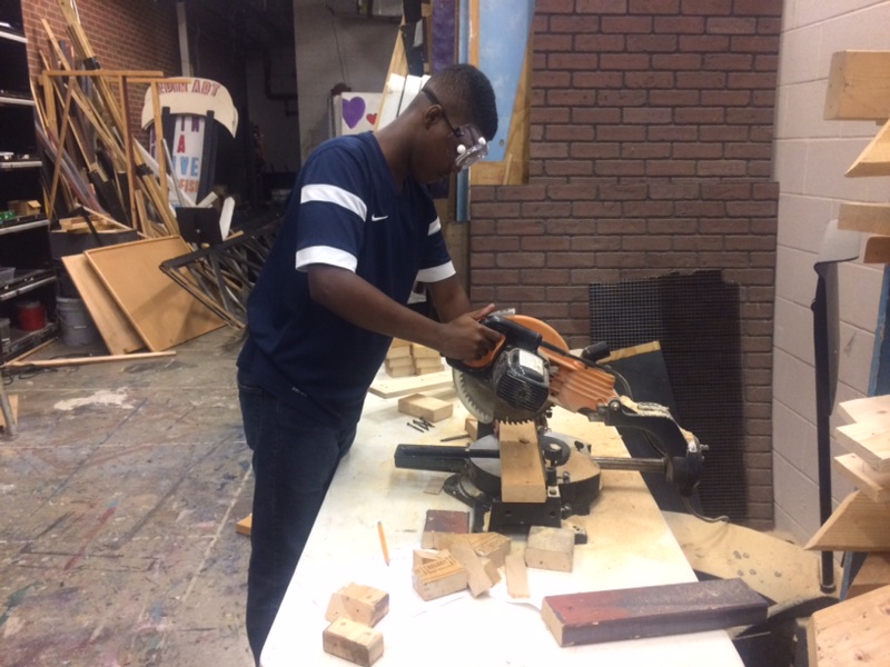 Master Carpenter Jason Harris cuts wood for the set of Is He Dead?