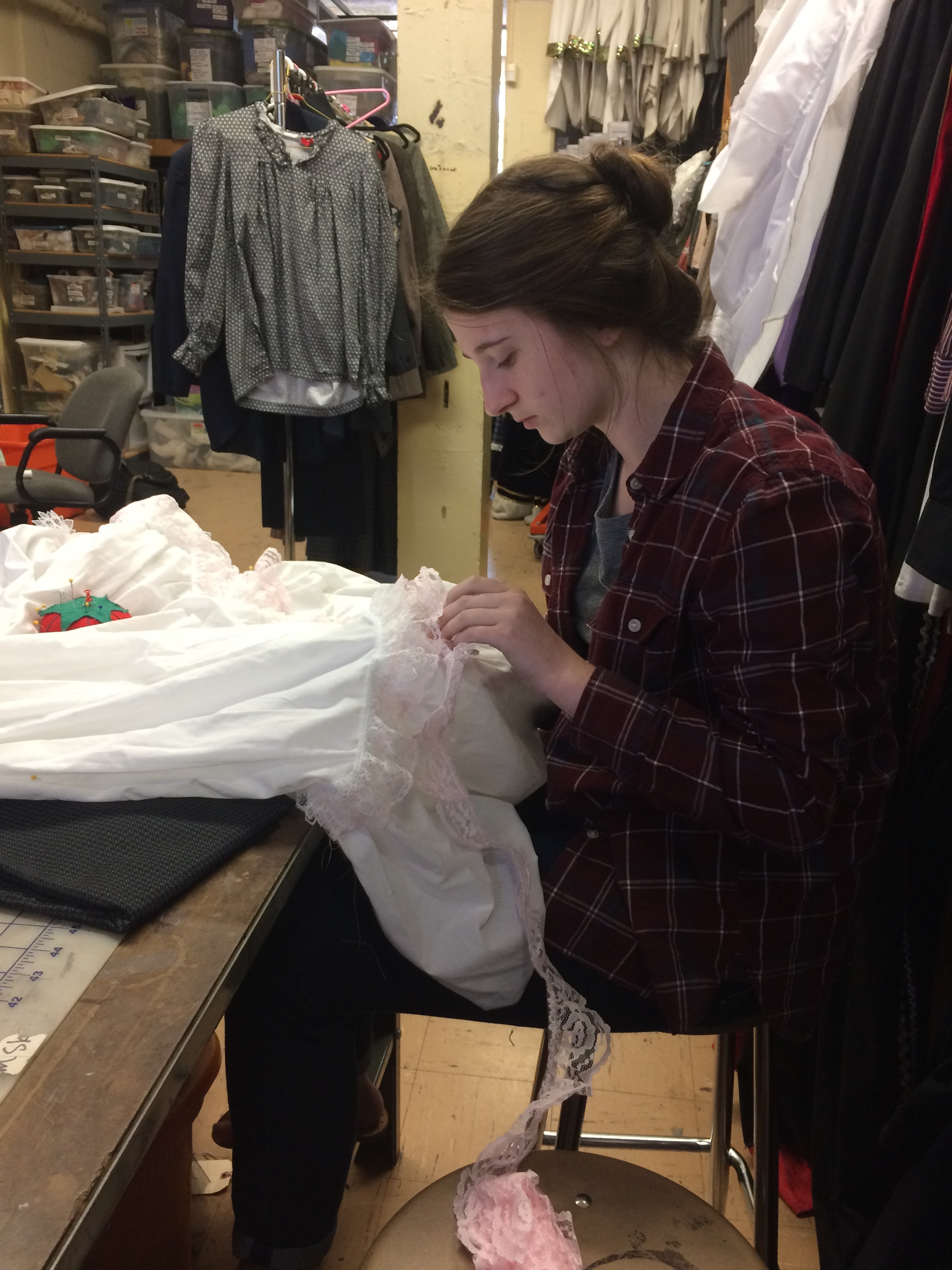 Costume Chairman Avery Moore pins meticulously adds details to a petticoat