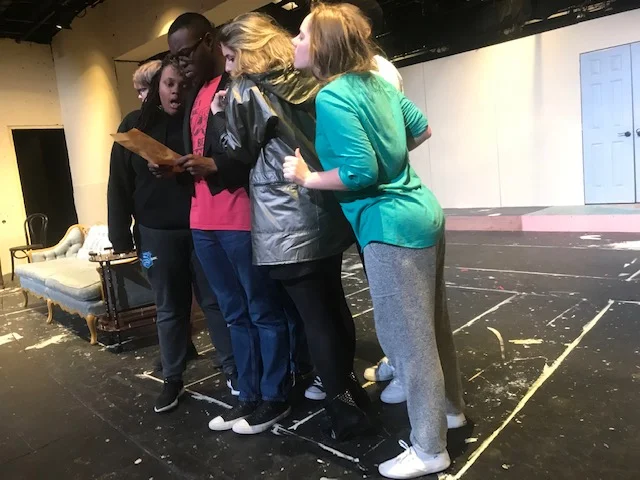The characters spy on Wadsworth (Rodney McKinner) as he reads classified information that will determine the fate of the evening.