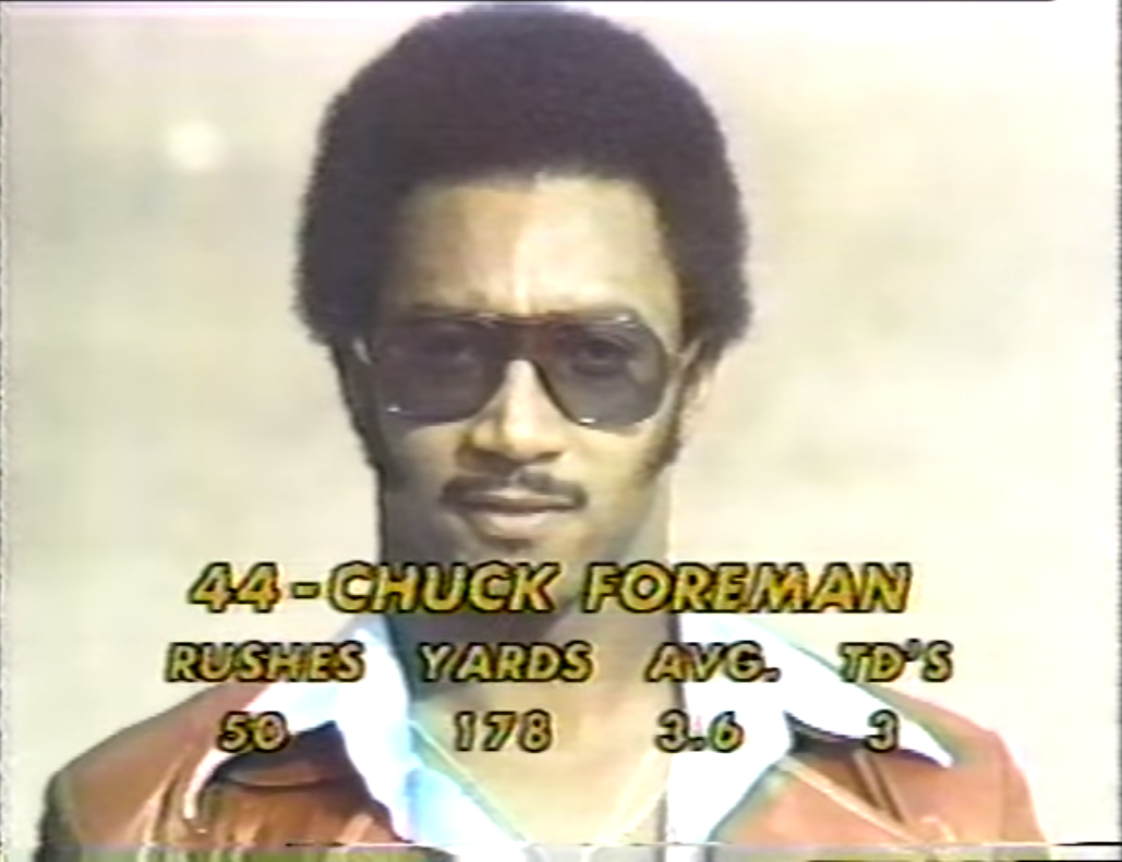 Chuck Foreman looking good here, but also trying too hard to look good. The chains, the leather jacket, the shades, and the sideburns? Seems like a lot of "cool guy" features for cool guy.