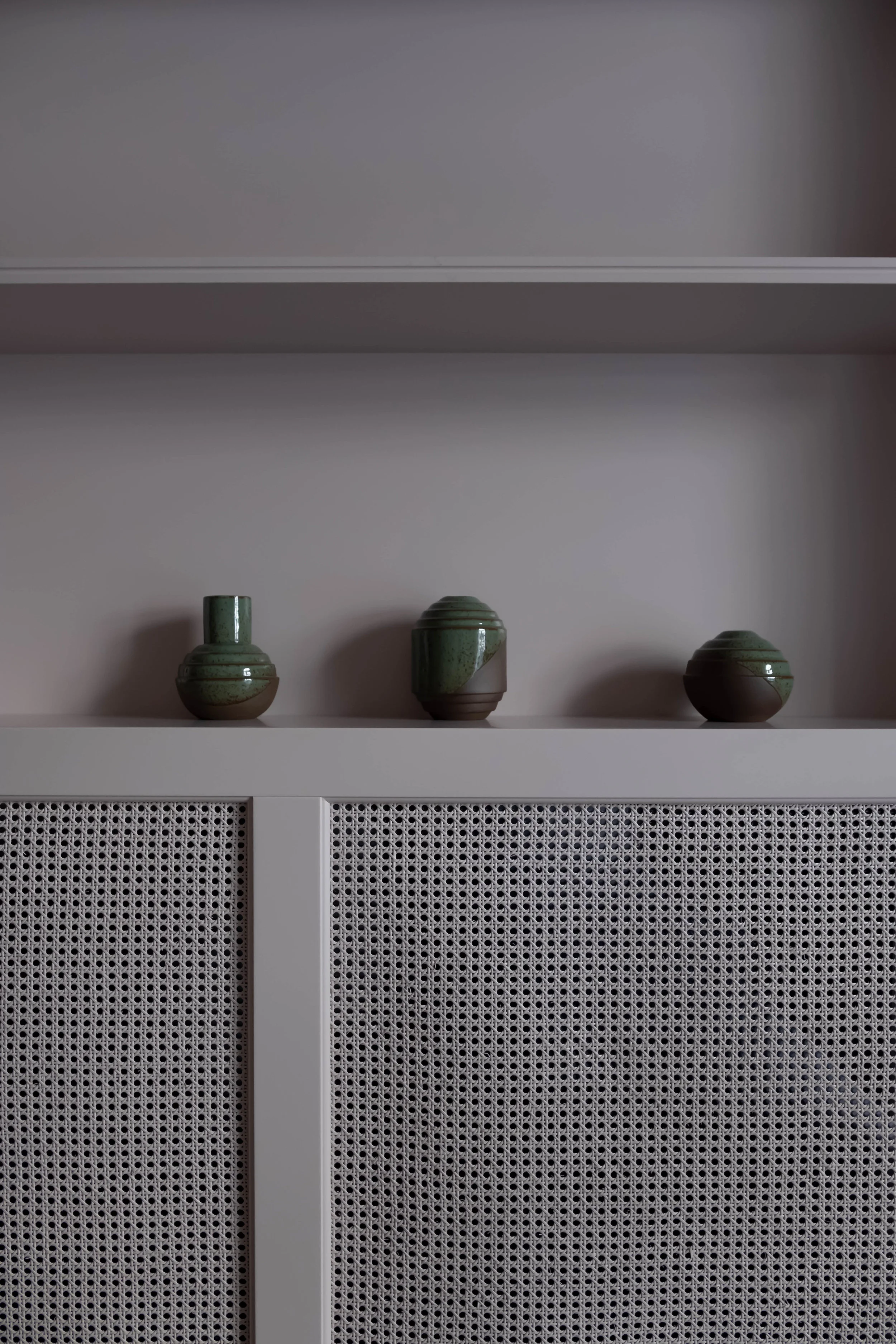 Many design elements are seen throughout including handmade pottery in a room.