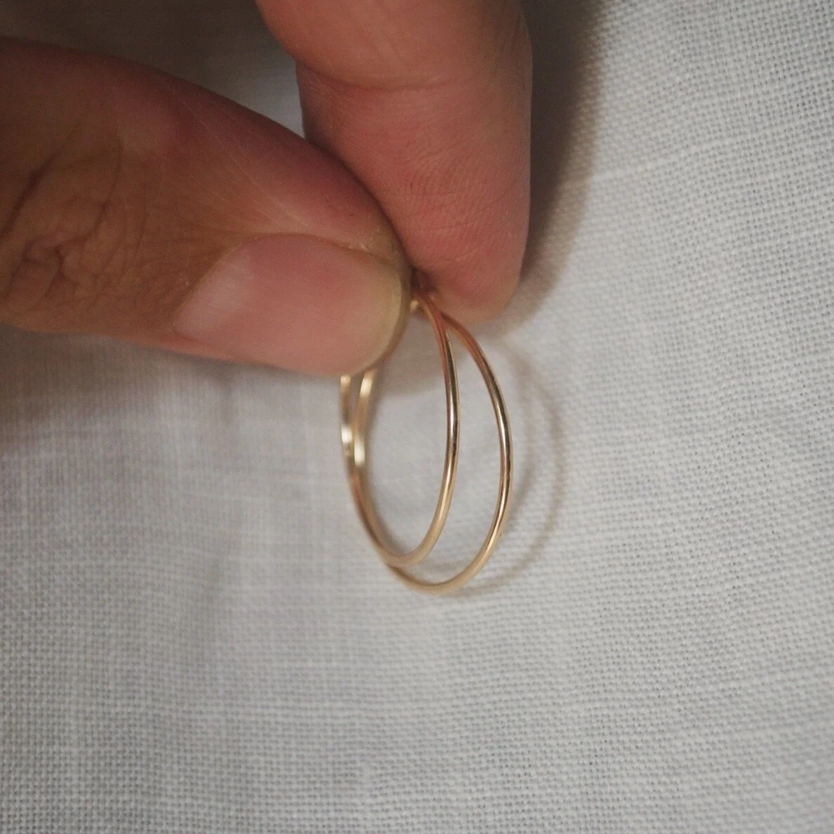 9ct gold hoop earrings held.JPG