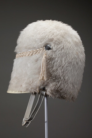 One of the hats featured in the Hats Off to Dr. Seuss Exhibition. Made by Stanbury Co., Kansas City, of leather, plastic, metal and white fake fur. A gift from San Diego State University in 1986. Ted was chosen honorary chairman of the Holiday Bowl football game between the Iowa Hawkeyes and the San Diego State Aztecs.