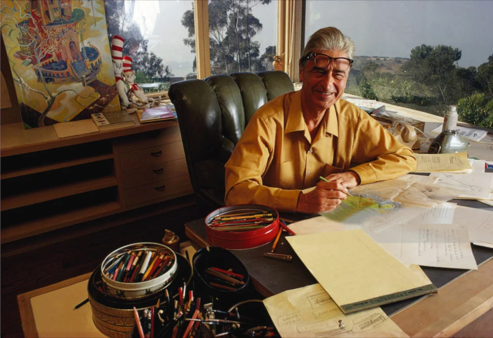 Each limited edition print will be accompanied by an 8" x 10" glossy photograph of the above 1969 photograph of Theodor Seuss Geisel at his drawing table with the original That Winter Spring Came Late. 