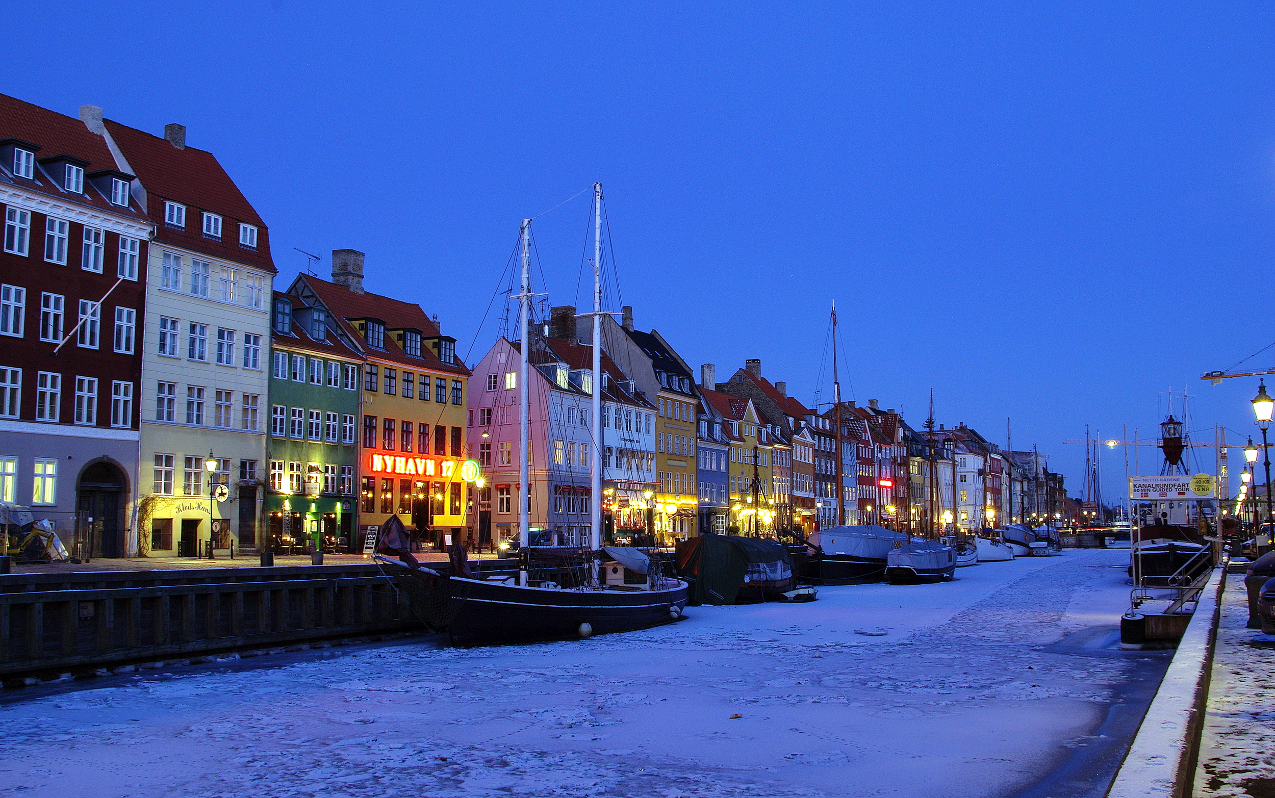  Winter picture at night of Nyhavn harbour, bright coloured houses, restaurants, bars and cafes. 
