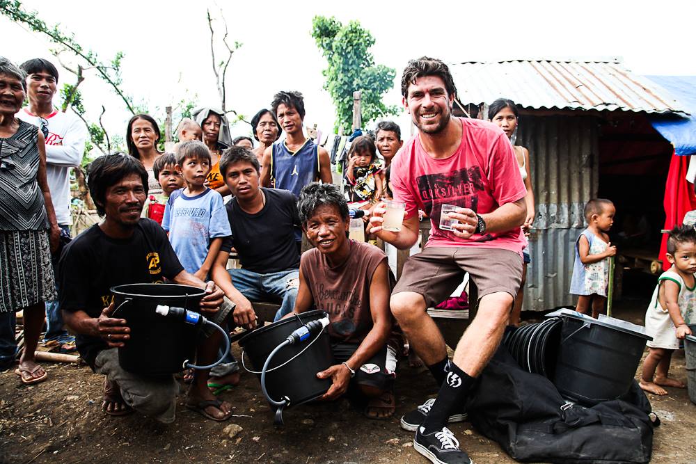 Caleb teaching locals how to use filters for clean water 