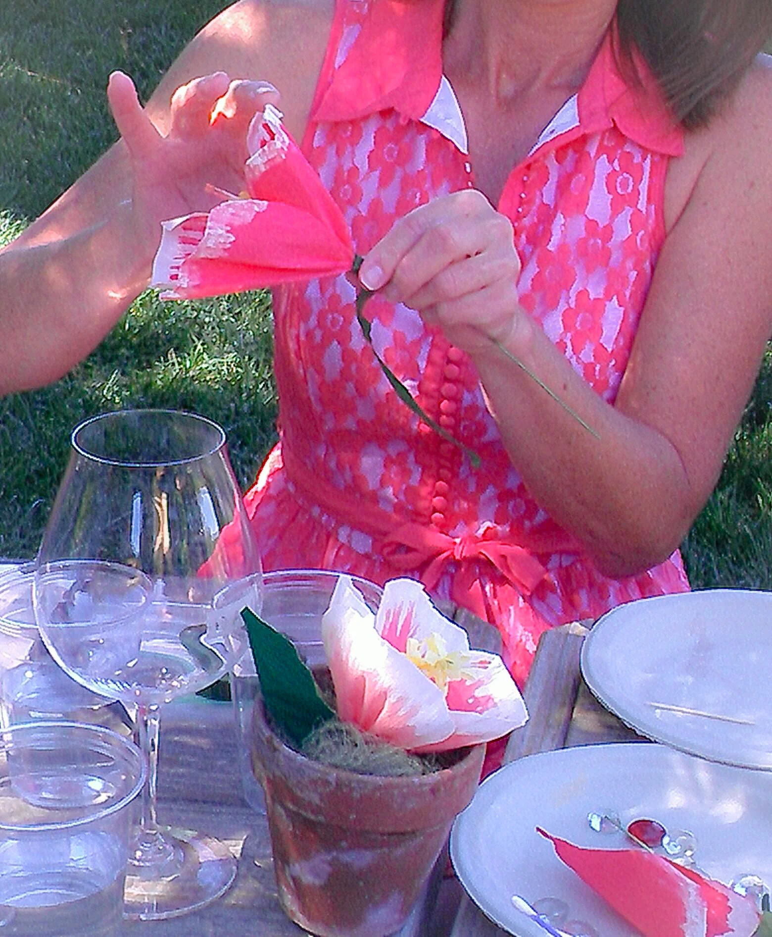 She matches her flower—lovely dress, lovely flower.