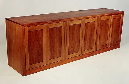 handmade hardwood cherry buffet with six flat frame and panel doors and sliding trays within