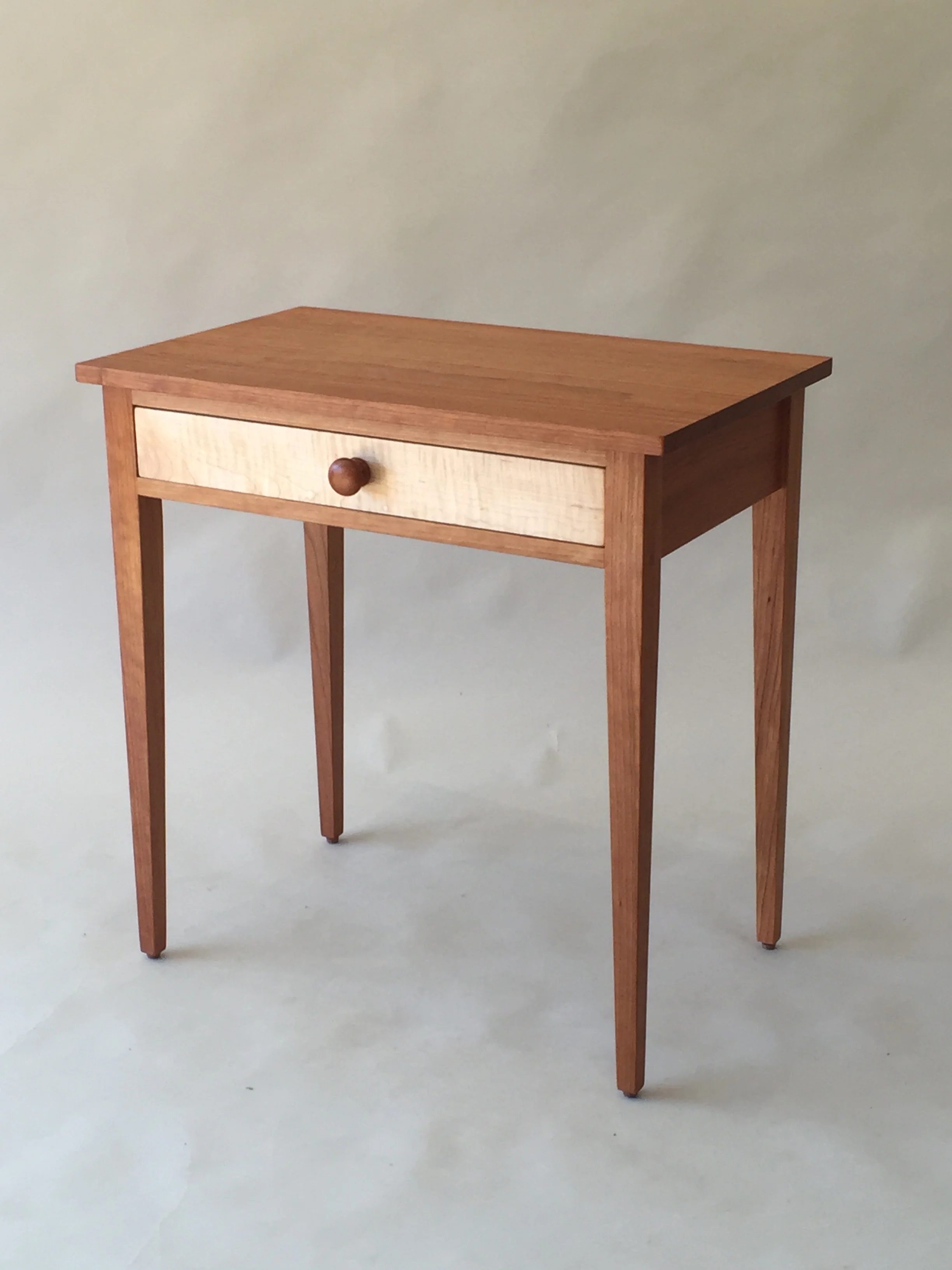 handmade hardwood cherry side table with curly maple drawer front and tapered legs