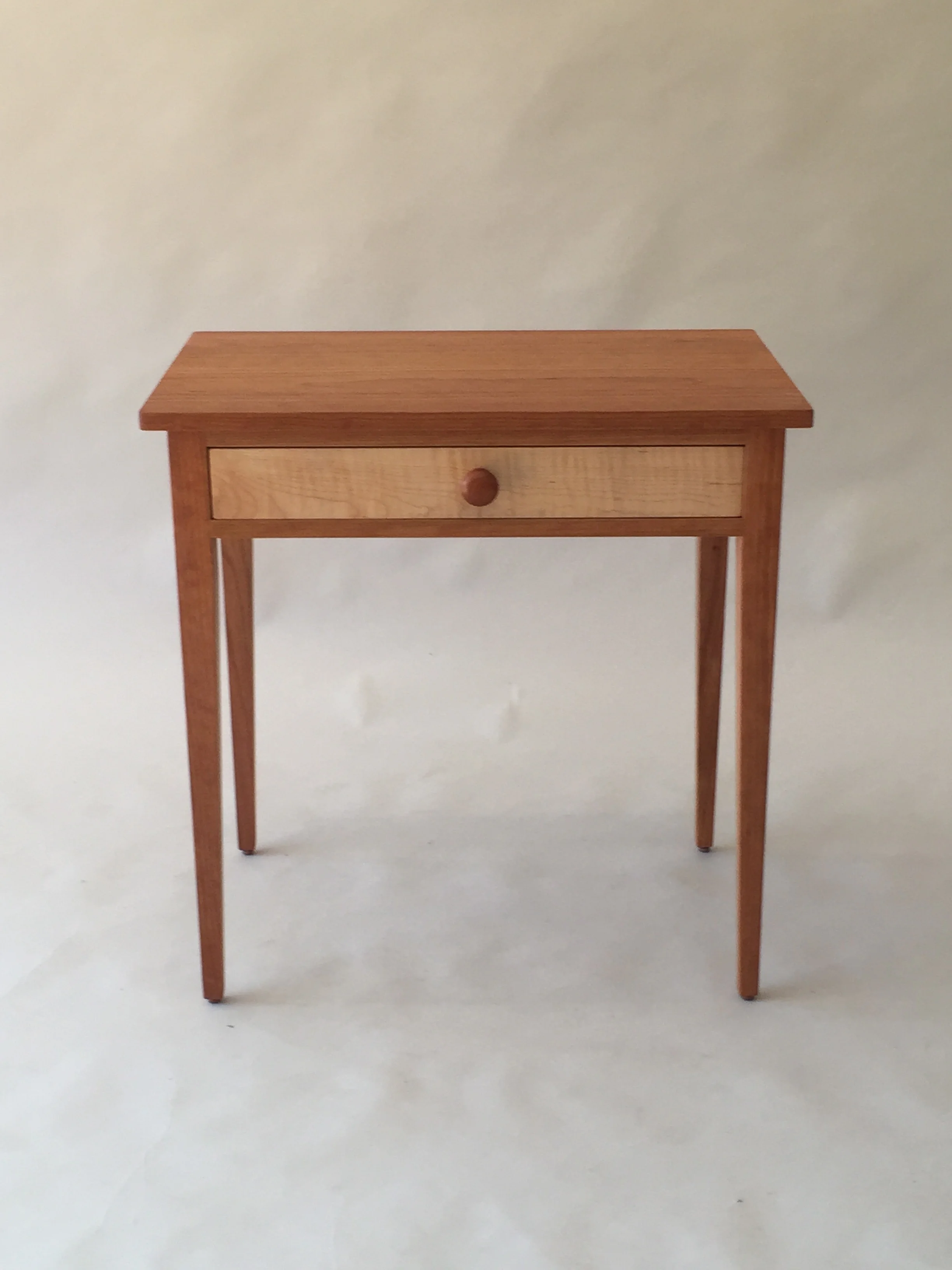 handmade hardwood cherry side table with curly maple drawer front and tapered legs