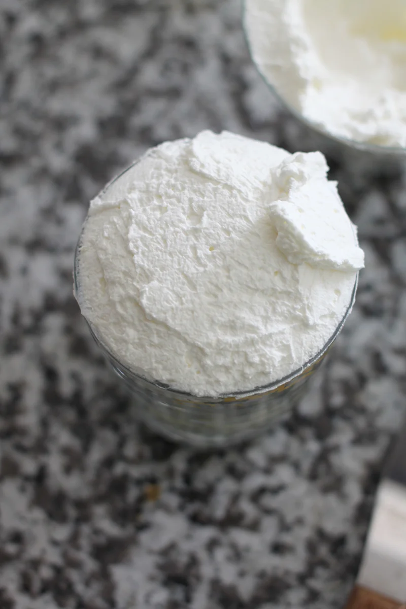  add another    genoise      circle brushed with    simple syrup     &nbsp;  then cover with    whipped cream   . 