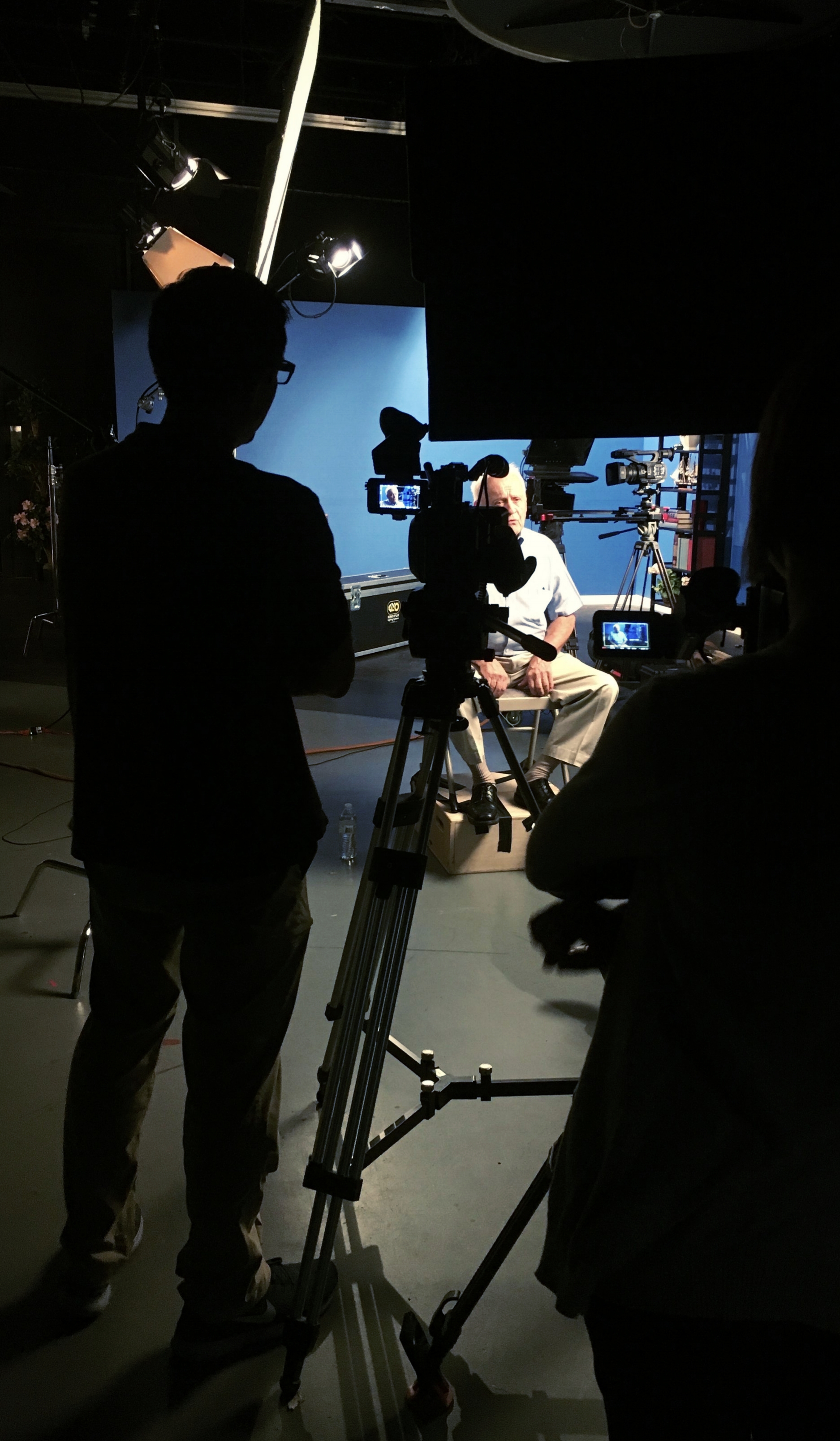 Adventist media pioneer Jim Hannum prepares for an interview with the center director as M.A. students Julio Munoz and Rachel Scribner record