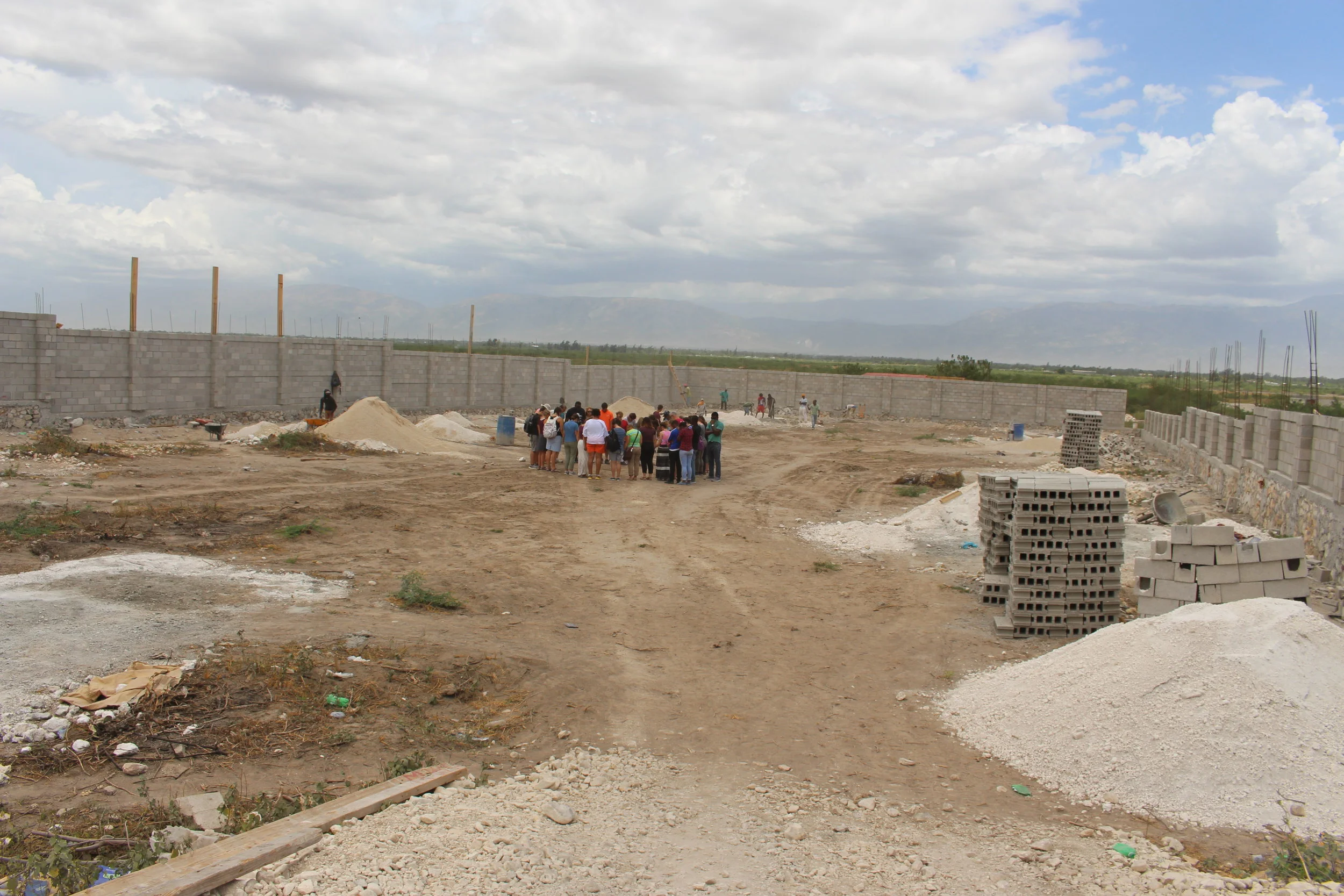 Our 2017 summer missions team standing in the middle of our House of Hope property, praying for the land and checking on the construction of our security wall. (July 5, 2017)