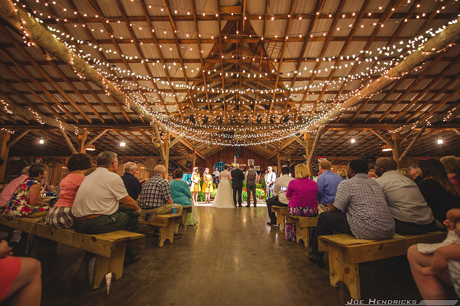  It started raining outside and the backup plan was this dark barn that was only lit by these over head stringed lights. I had to make a decision before they walked down the aisle on wether or not to use flash. Because I trust the Nikon D4 so much, I went with natural light and it turned out amazing!