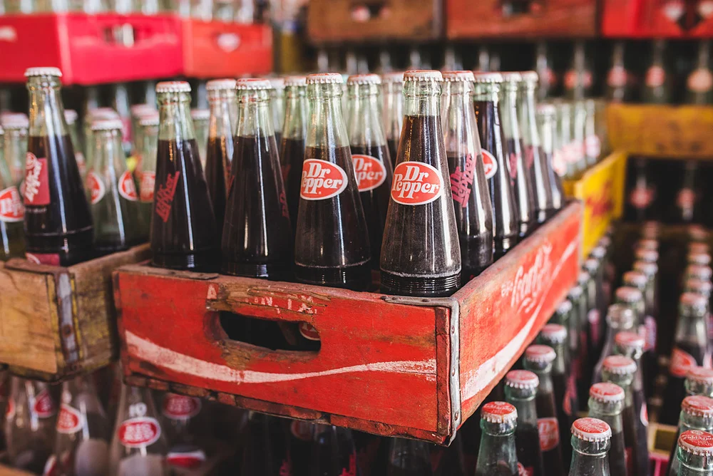 Recycled bottles of Dr. Pepper that are lying around.