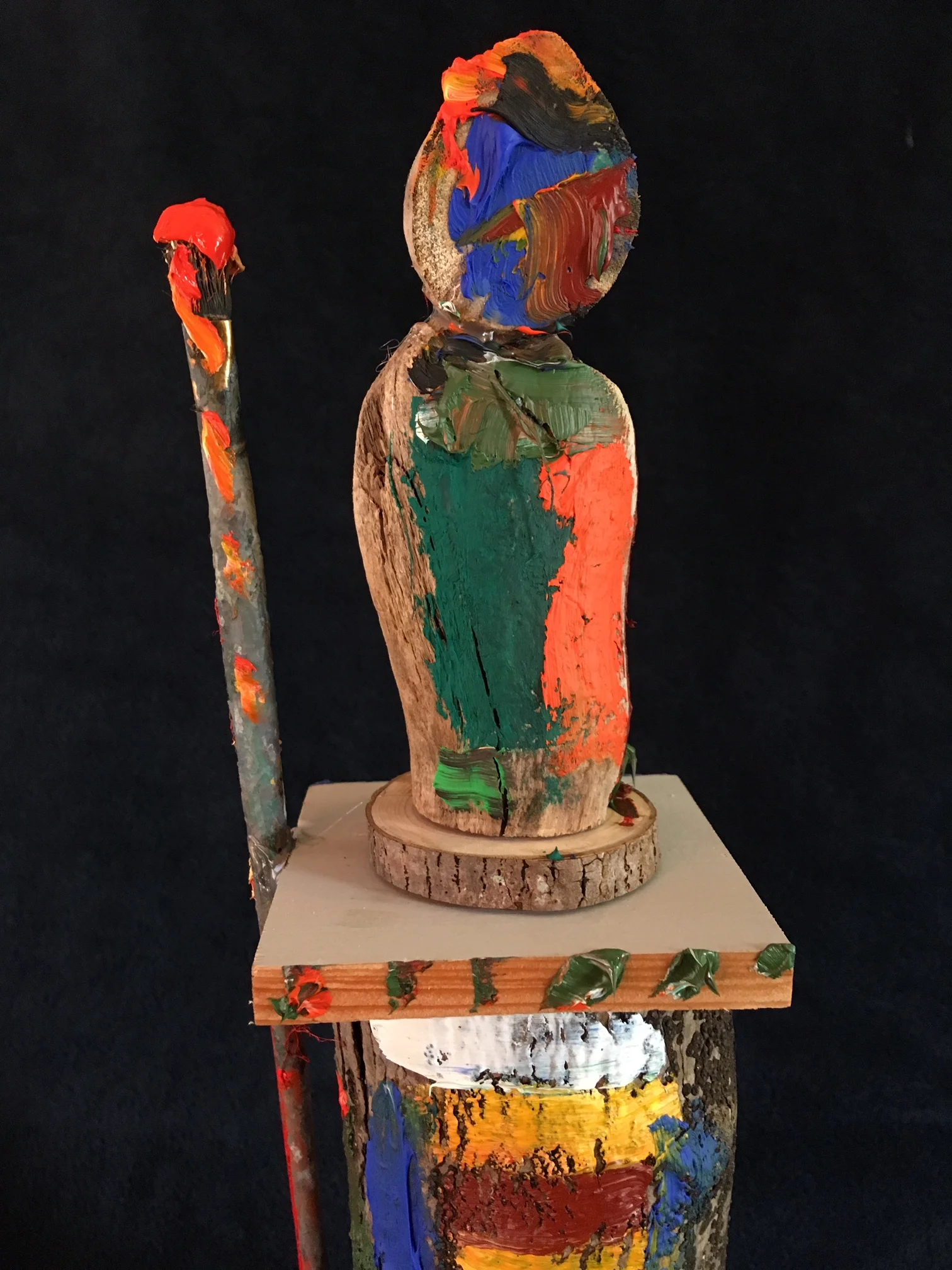 oil paint, paintbrush and wood sculpture on wooden base