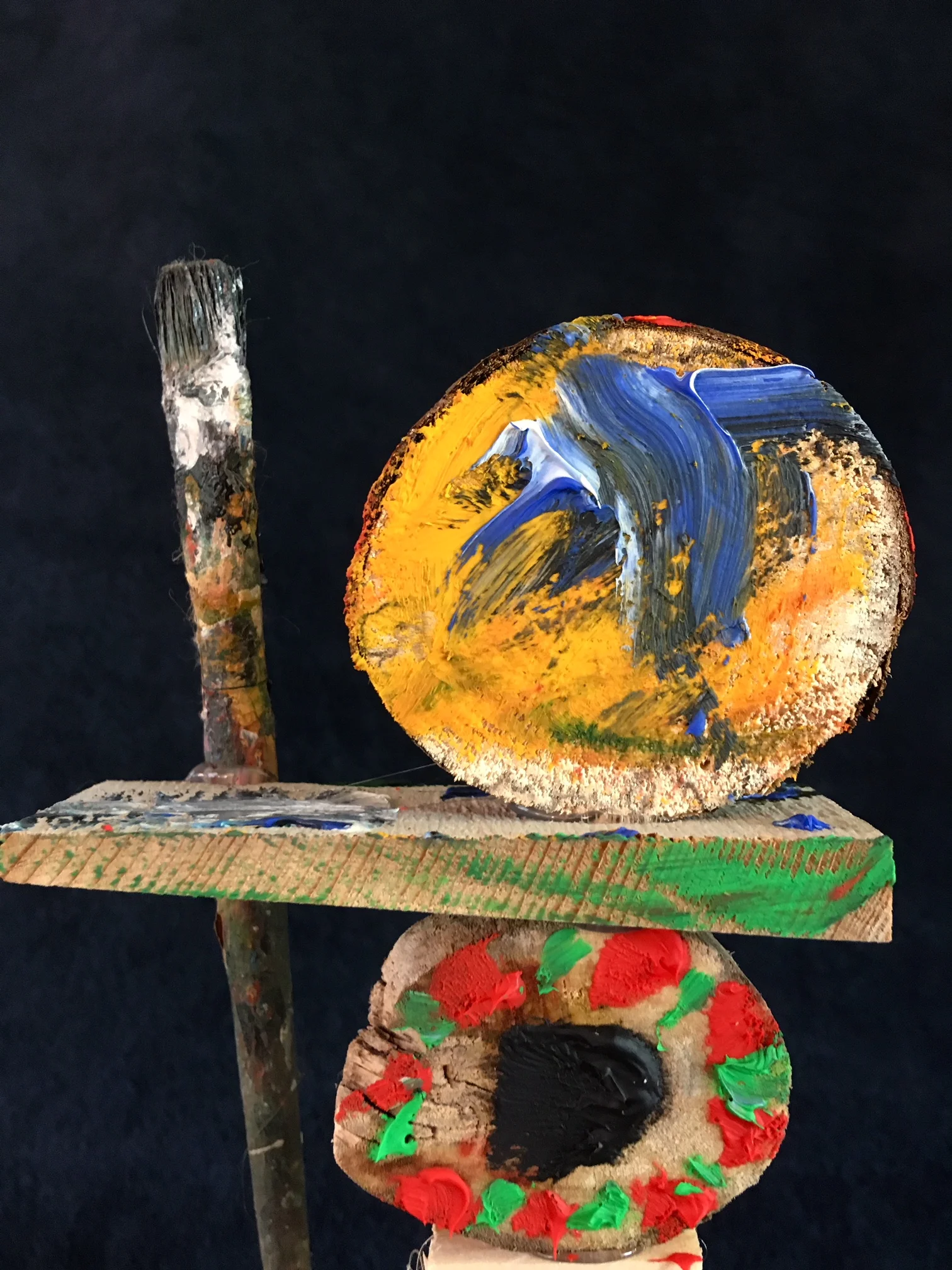 oil paint, paintbrush and wood sculpture on wooden base