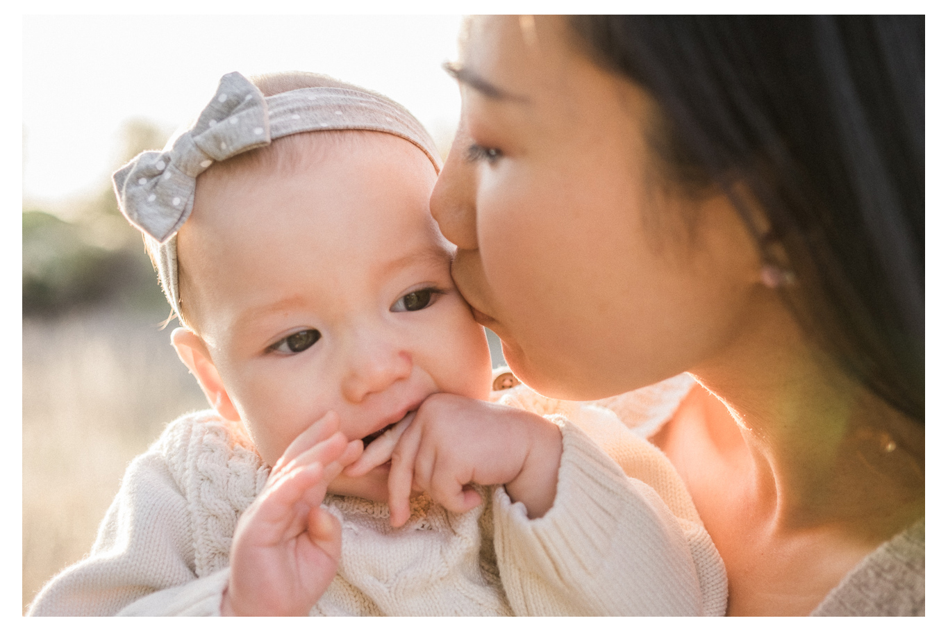 family fun outdoor session mom and baby one year old los penasquitos canyon preserve san diego portraits mom kiss baby