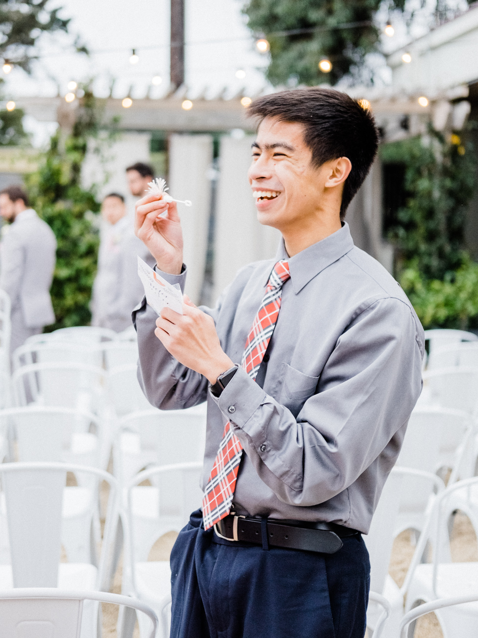 guests blowing bubbles at wedding