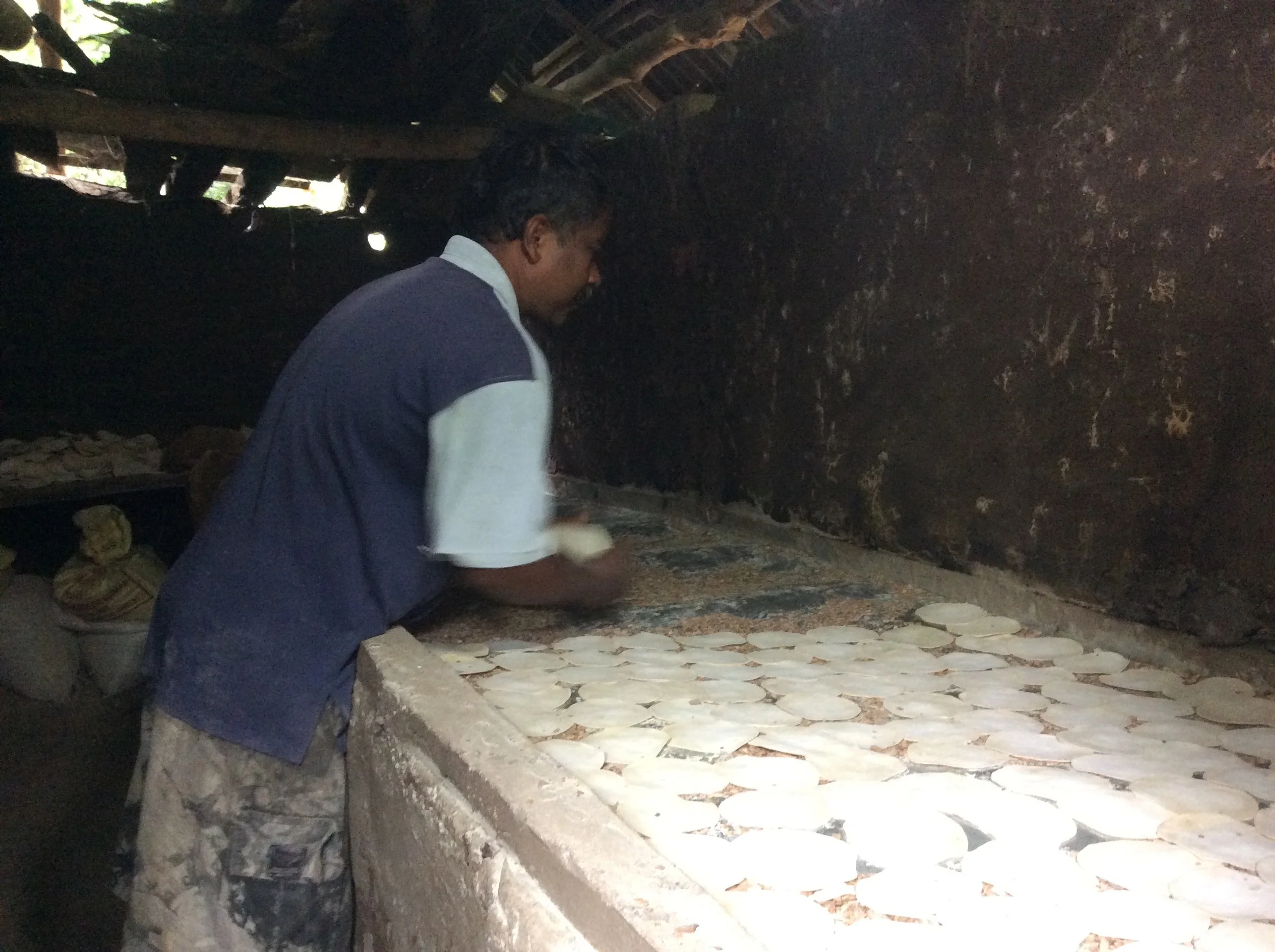 Laying out papadams in the wood fired 'oven' out back