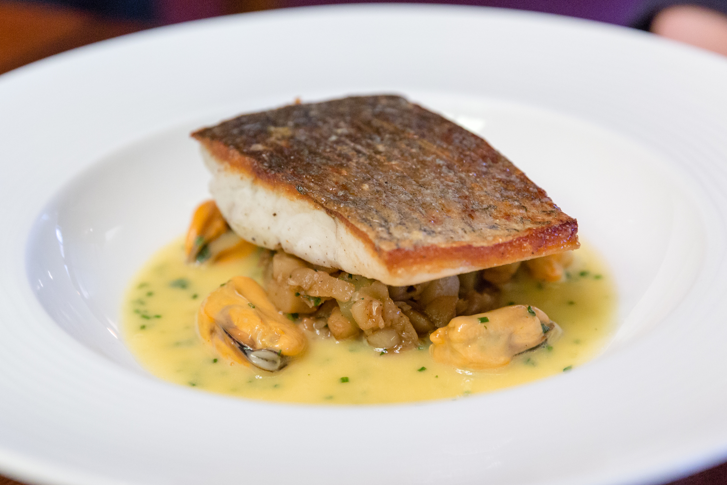 Fillet of Stonebass, Crushed Jerusalem Artichokes, Cider Butter Sauce and Mussels