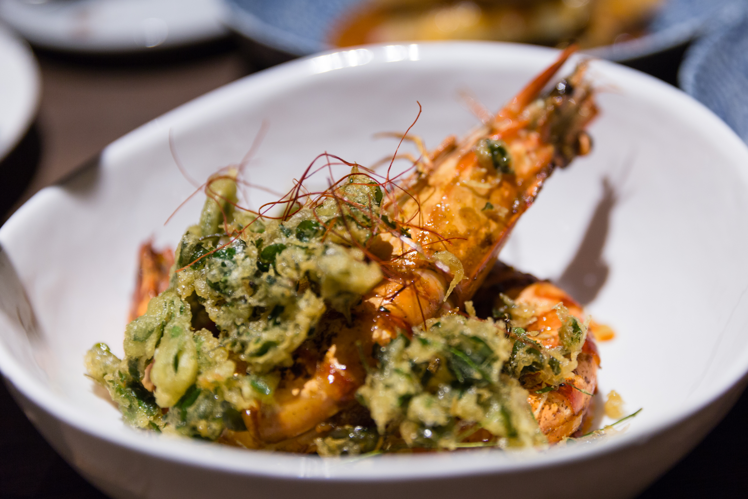 Grilled Aromatic King Prawns, Dry Red Curry, Thai Basil, Green Peppercorn, Tempura of Moringa Leaf