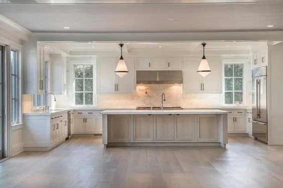 Designed by Michael Davis in Sagaponack, NY, this kitchen was a huge source of inspiration. It has the perfect blend of white and wood for a similar coastal vibe we're going for. | Source: Curbed